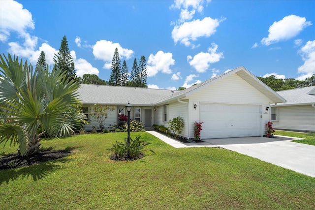 ranch-style home featuring a garage and a front lawn