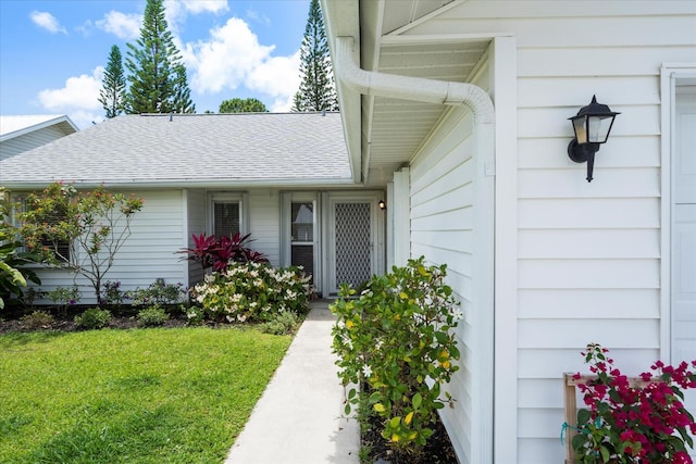 entrance to property with a lawn