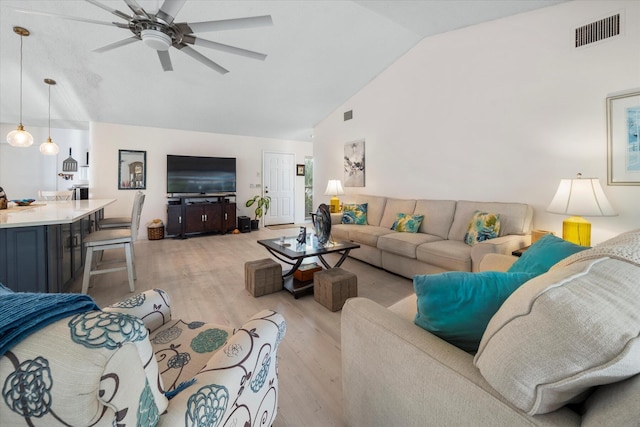 living room featuring light hardwood / wood-style flooring, ceiling fan, and lofted ceiling