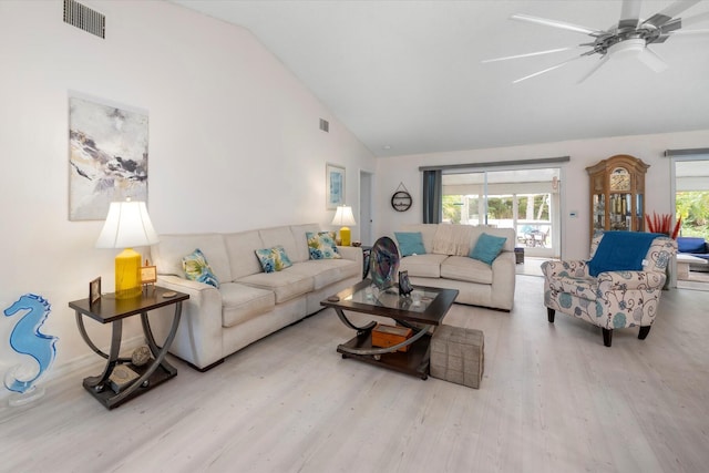 living room featuring ceiling fan, high vaulted ceiling, and light wood-type flooring