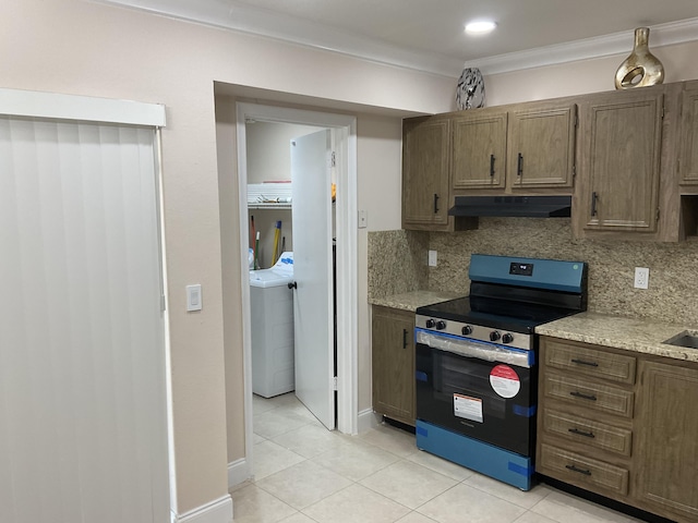 kitchen with light tile patterned floors, tasteful backsplash, black / electric stove, and crown molding