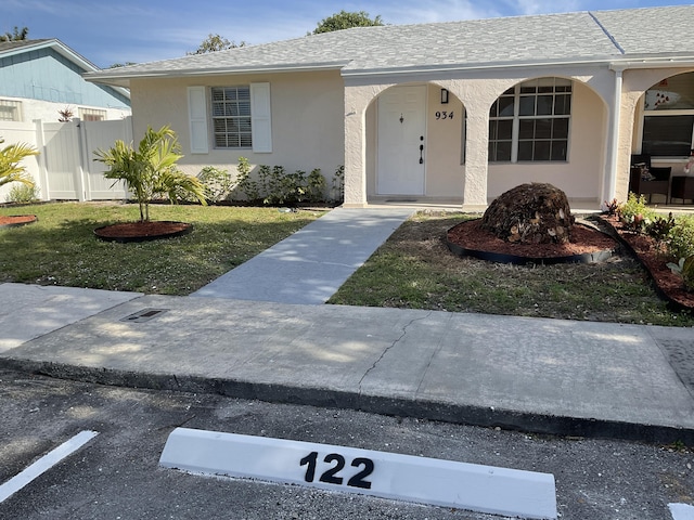 single story home with a porch and a front lawn