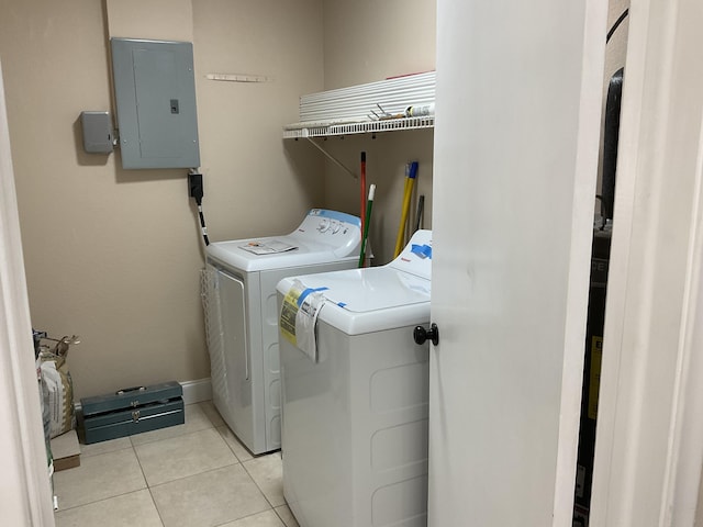 laundry area with washing machine and clothes dryer, electric panel, and light tile patterned flooring