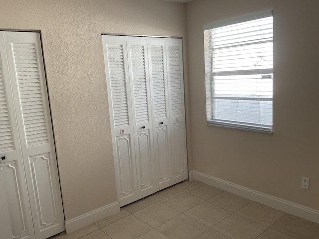 unfurnished bedroom featuring light tile patterned floors