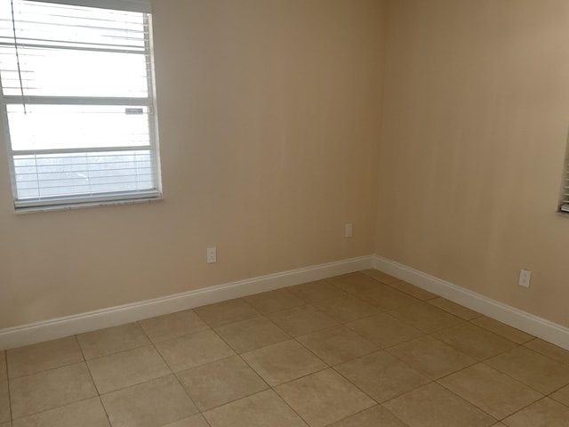 unfurnished room featuring light tile patterned floors