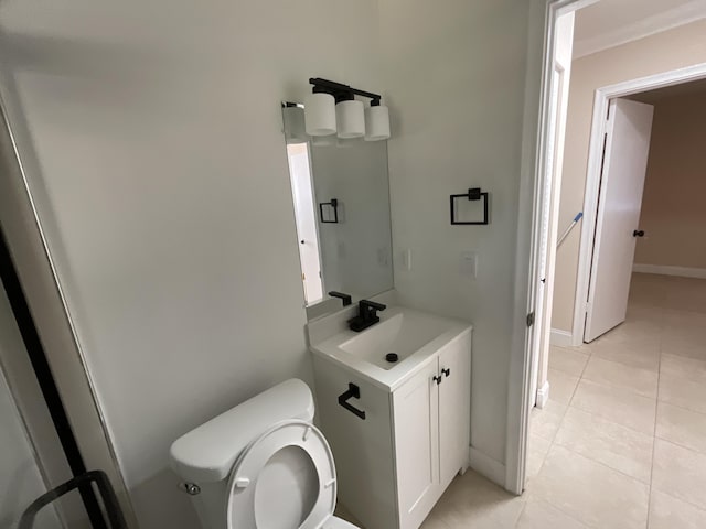 bathroom featuring tile patterned flooring, vanity, and toilet