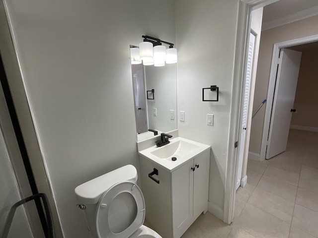 bathroom featuring tile patterned floors, vanity, toilet, and ornamental molding