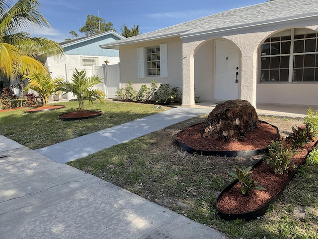 ranch-style home with a front lawn