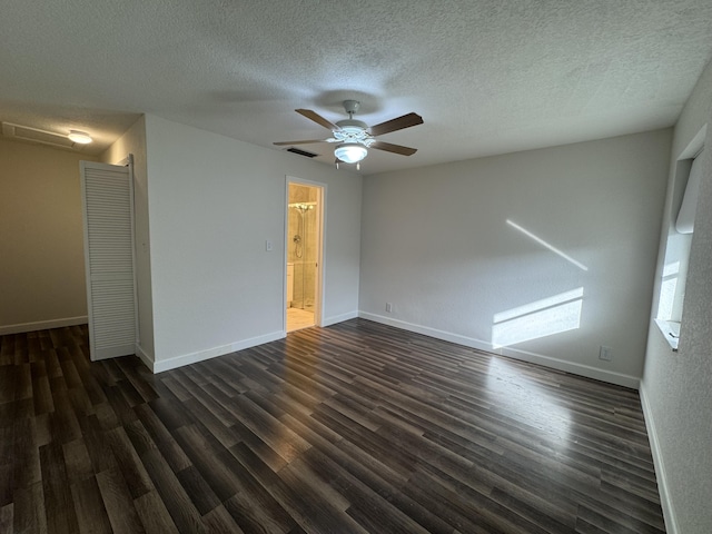 empty room with a textured ceiling, ceiling fan, and dark wood-type flooring