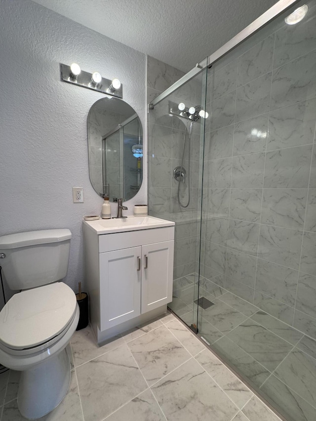 bathroom with vanity, a shower with shower door, a textured ceiling, and toilet