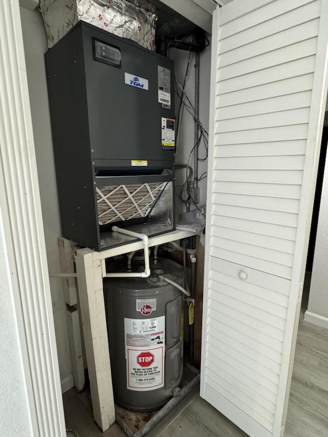 utility room featuring water heater