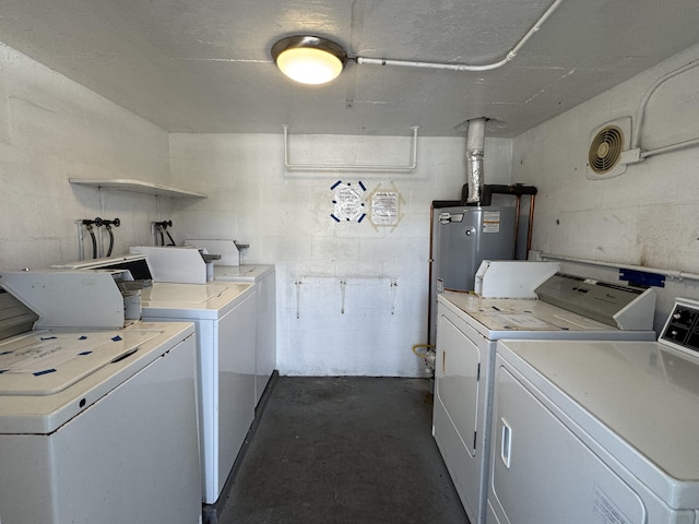 laundry area with water heater and washer and dryer