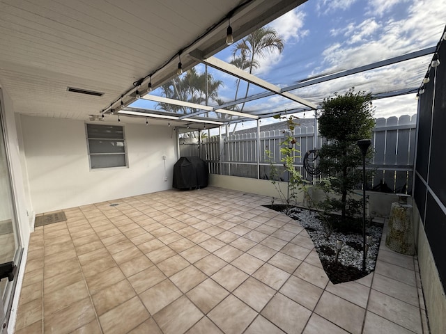 view of patio featuring a lanai and grilling area