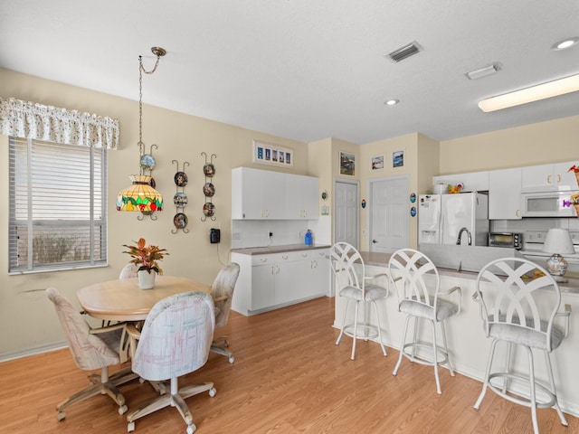 dining room with light hardwood / wood-style floors