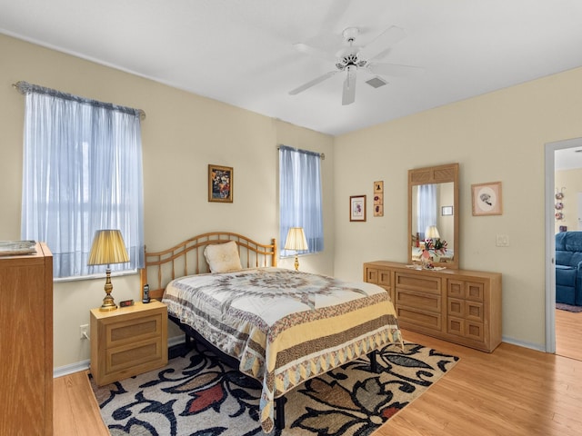 bedroom featuring ceiling fan and light hardwood / wood-style flooring