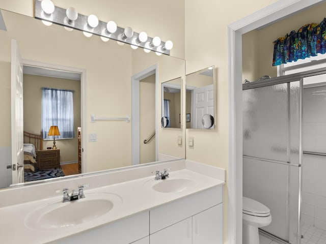 bathroom with vanity, an enclosed shower, and toilet