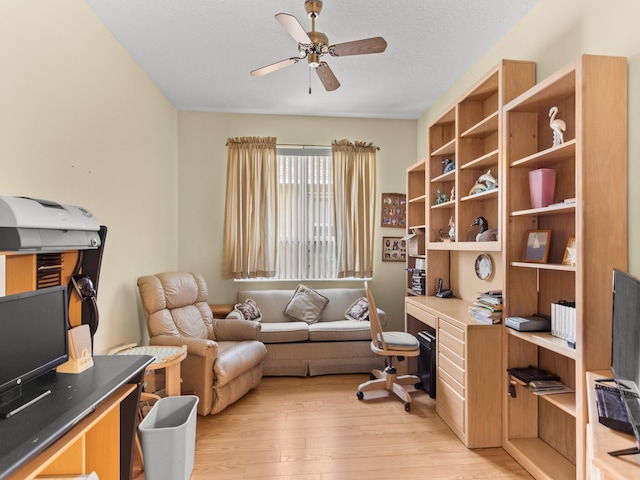 office area with ceiling fan, light hardwood / wood-style flooring, and a textured ceiling