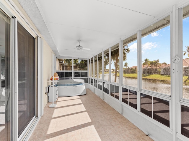 unfurnished sunroom featuring a water view