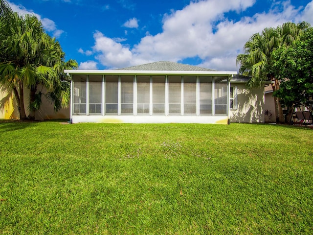 rear view of property featuring a yard