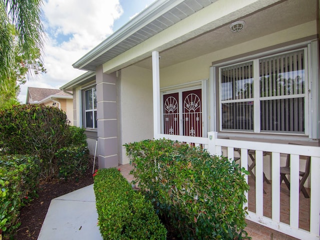 view of exterior entry with covered porch