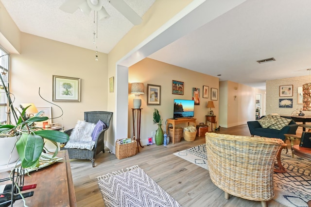 living room featuring light wood-type flooring and ceiling fan