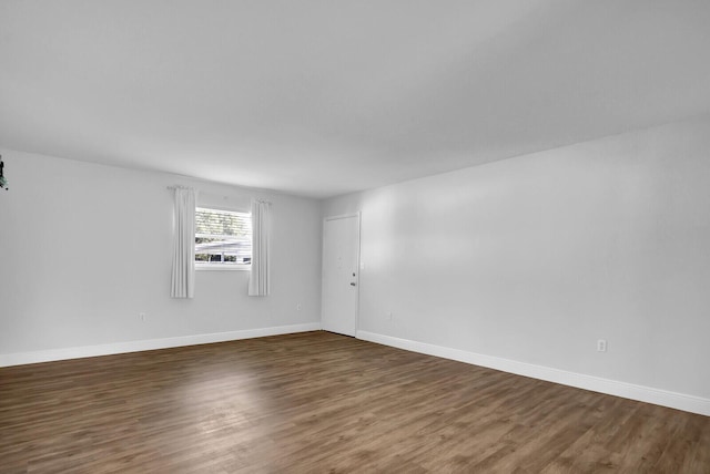 unfurnished room featuring dark hardwood / wood-style flooring