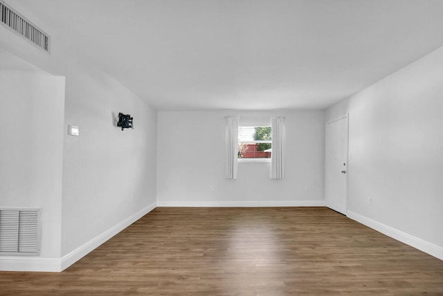 spare room with hardwood / wood-style flooring