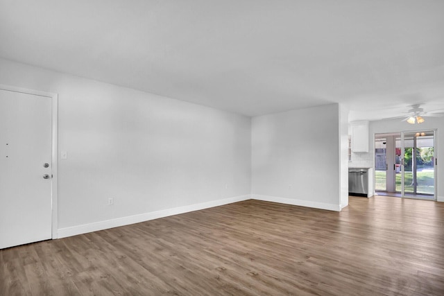 unfurnished living room with hardwood / wood-style flooring and ceiling fan