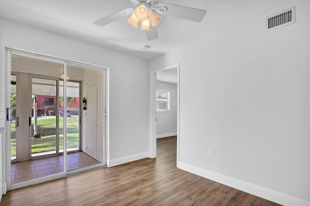 empty room featuring hardwood / wood-style flooring, plenty of natural light, and ceiling fan