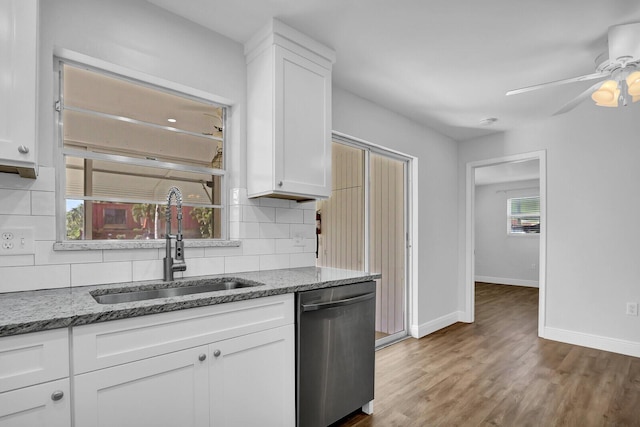 kitchen with dishwasher, white cabinetry, a healthy amount of sunlight, and sink