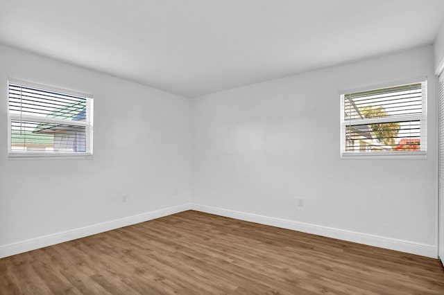 unfurnished room with wood-type flooring