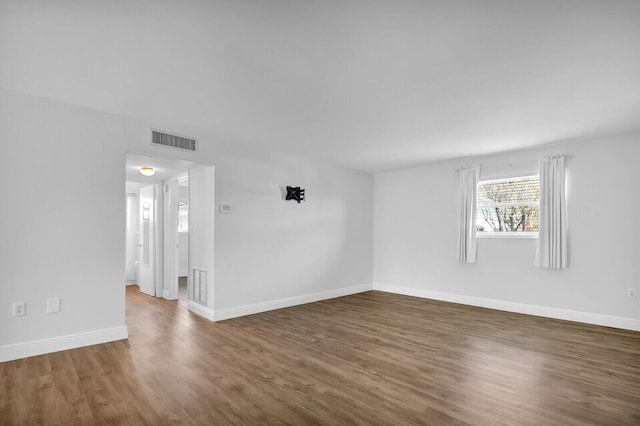 spare room with dark wood-type flooring