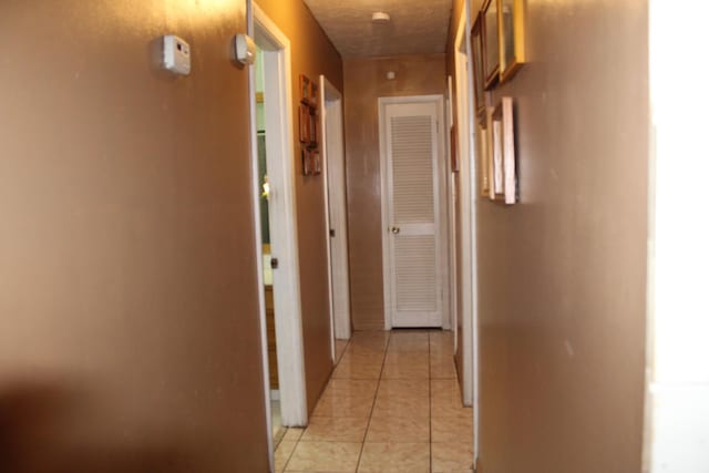 corridor with light tile patterned flooring