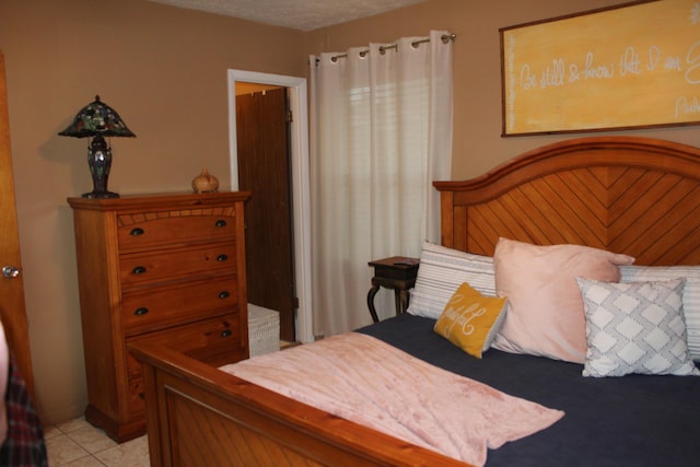 tiled bedroom featuring a textured ceiling