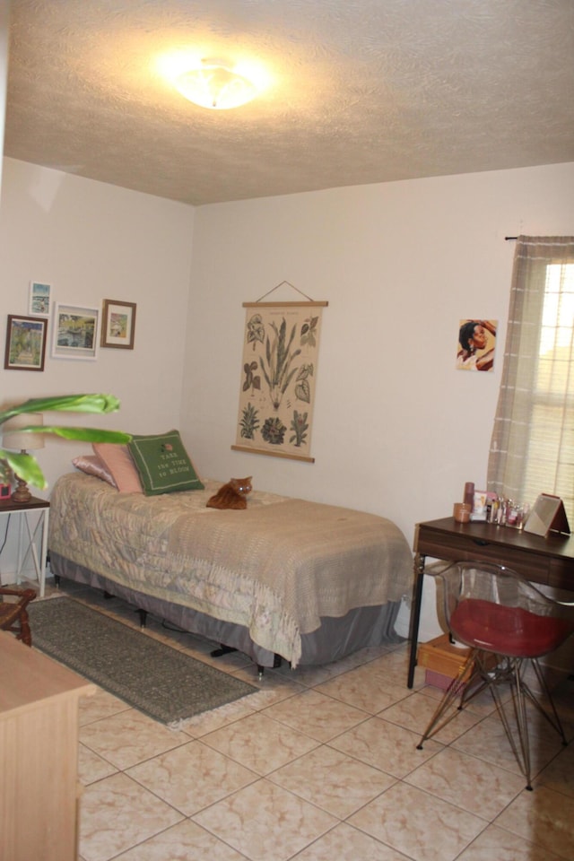 tiled bedroom with a textured ceiling