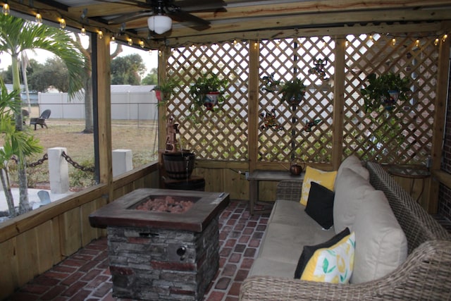 view of patio / terrace featuring ceiling fan and a fire pit