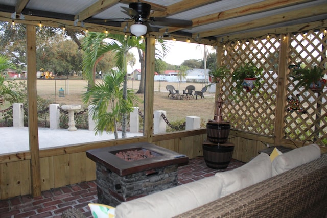 view of patio / terrace with a gazebo, an outdoor living space with a fire pit, and ceiling fan