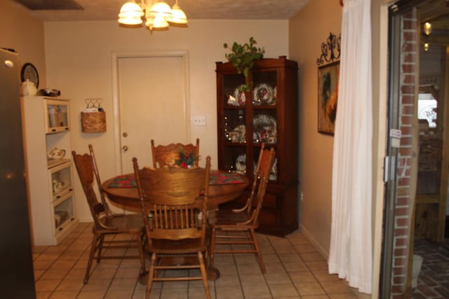 tiled dining area featuring a notable chandelier