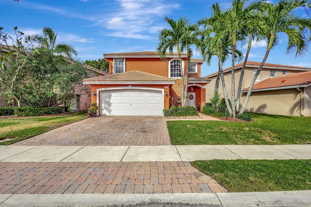 mediterranean / spanish home featuring a garage and a front lawn