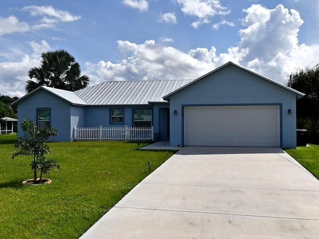 ranch-style house with a garage and a front lawn