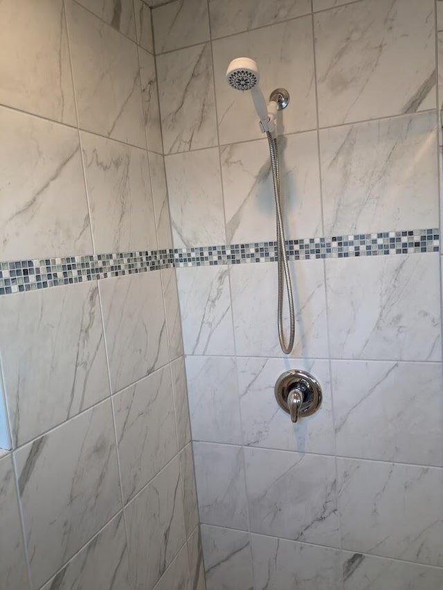 bathroom with tiled shower