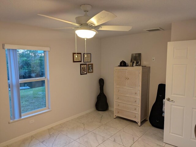 sitting room featuring ceiling fan