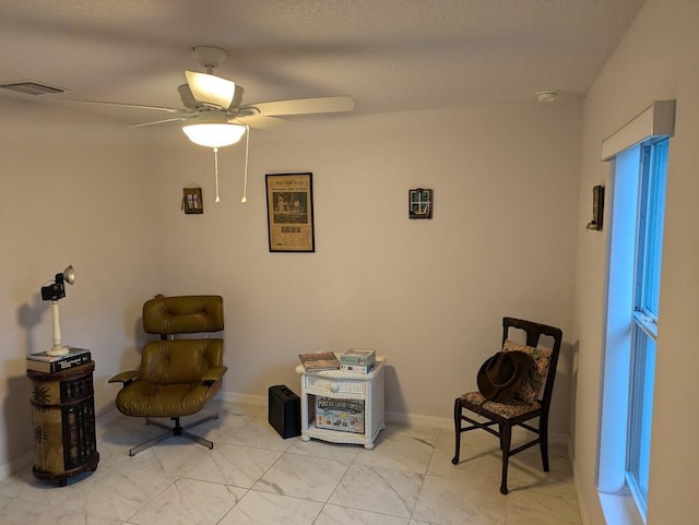 sitting room with ceiling fan