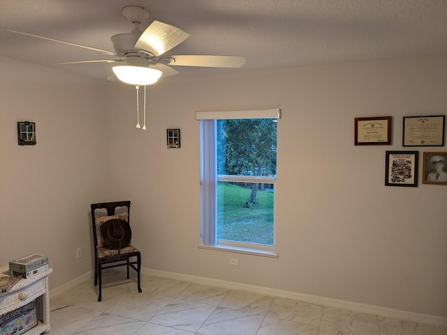 living area with ceiling fan