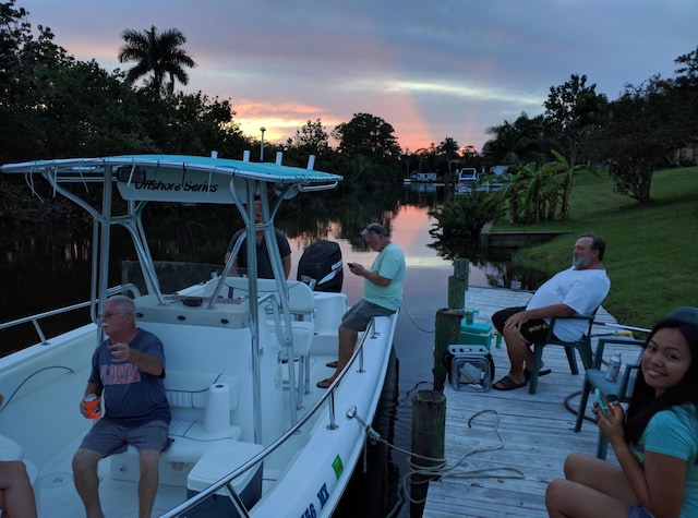 view of dock featuring a yard and a water view