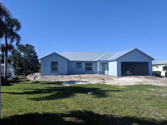 ranch-style home with a garage and a front yard