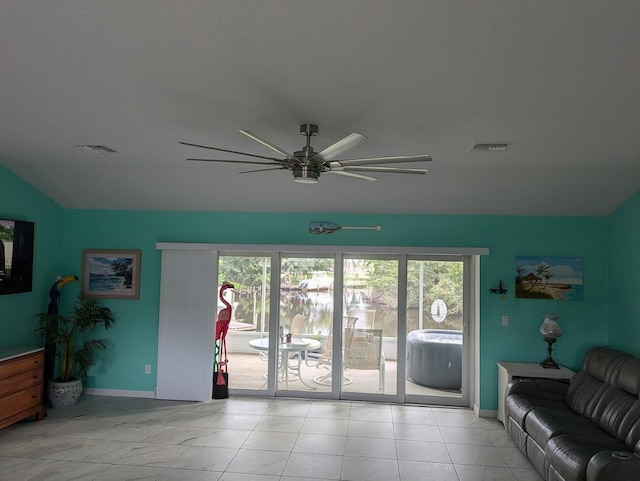 living room featuring light tile patterned flooring and ceiling fan