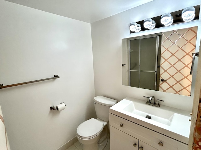 bathroom with tile patterned flooring, vanity, and toilet