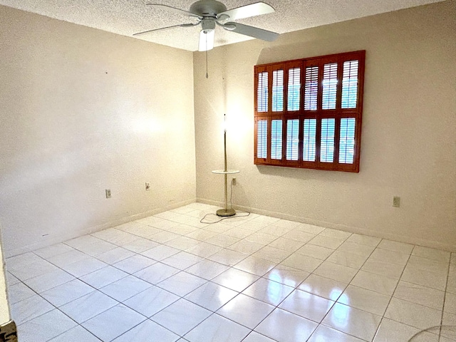 unfurnished room with tile patterned flooring, a textured ceiling, and ceiling fan