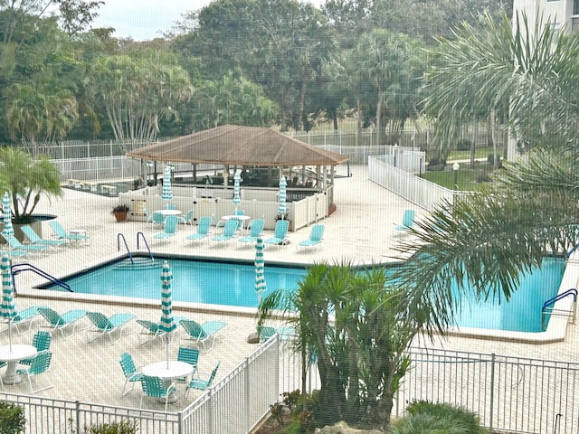 view of swimming pool with a gazebo and a patio area